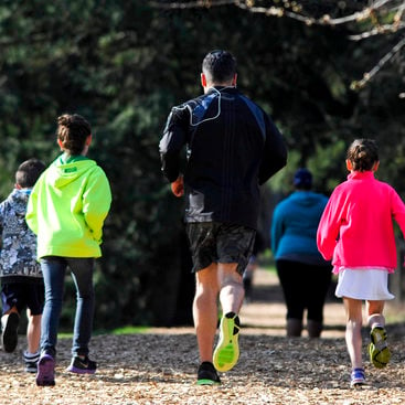 photo of a family running on the fitness trail