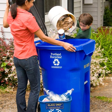 photo of mom and son emptying the recycling bin
