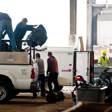 photo of men unloading waste at the transfer station