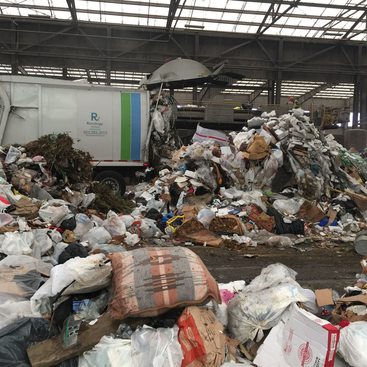 garbage truck emptying its load at Metro's Central transfer station
