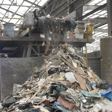 Unsalvageable dry waste drops off the end of the line where it has been picked through and sorted by Recology employees.