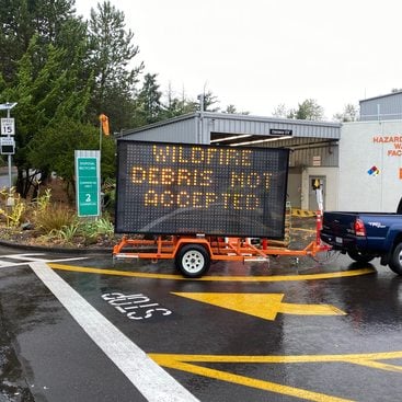 a sign that reads "wildfire debris not accepted"