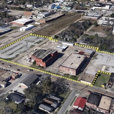 aerial image of a parcel with buildings, outlined with a dotted yellow line to indicate the parcel boundaries