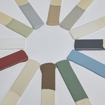 Twelve stirsticks dipped in the MetroPaint Colors 