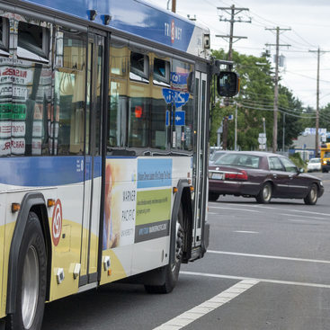 TriMet bus line 72 at an intersection on 82nd Avenue with other vehicles 