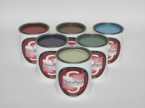 6 cans of paint with MetroPaint labels are arranged in a pyramid. The paint can lids are removed to show the colors of paint inside the cans, which are shades of green, brown and blue.