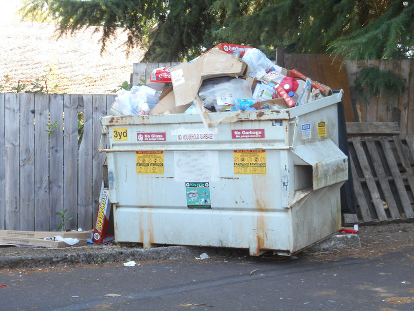dumpster overflowing with materials to be recycled
