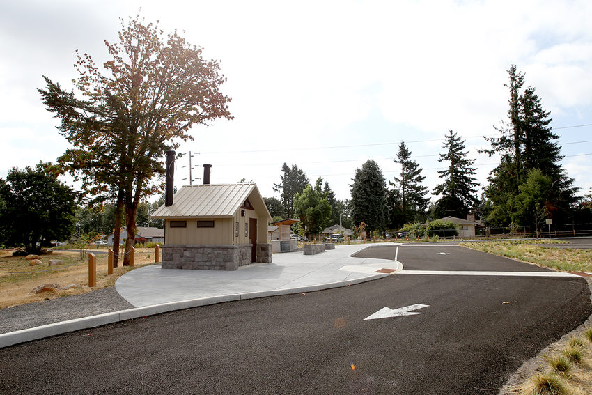 A parking lot with a restroom at the entrance of Newell Creek Canyon Nature Park.