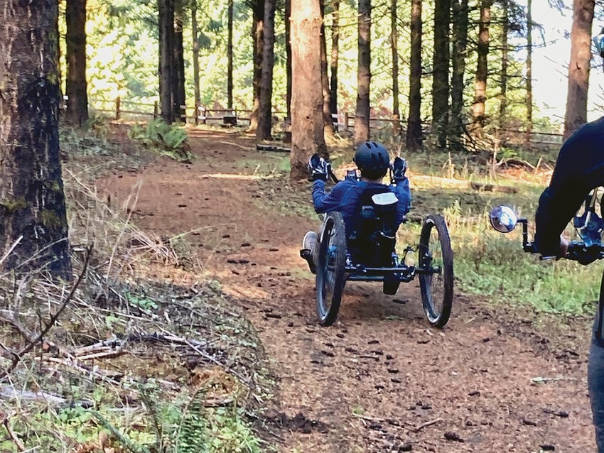 A hand tricyclist rides a trail at Chehalem Ridge Nature Park.