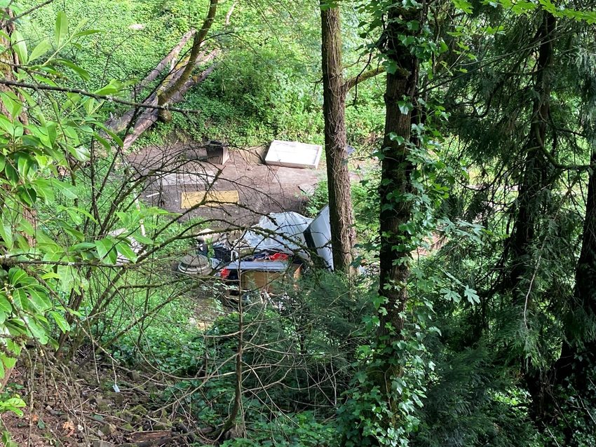 An image of trash that has been dumped at the bottom of a hill