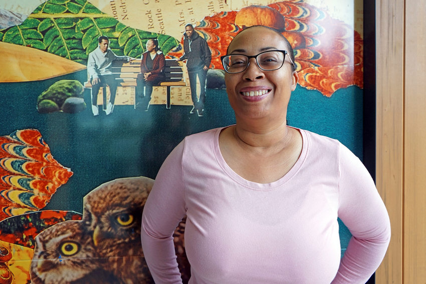 Woman standing in front of a colorful photo collage