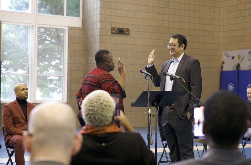 Councilor Duncan Hwang raises his right hand as he is sworn in by Oregon Supreme Court Justice Adrienne Nelson.