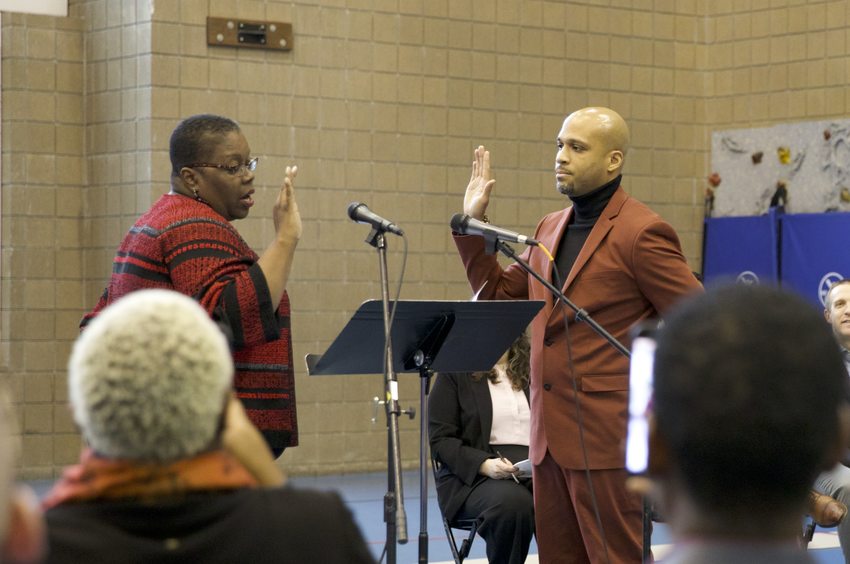 Councilor Ashton Simpson raises his right hand and takes the oath of office from Oregon Supreme Court Justice Adrienne Nelson.