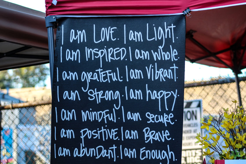 A sign that reads "I am love. I am light. I am inspired. I am whole. I am grateful. I am vibrant. I am strong. I am happy. I am mindful. I am secure. I am positive. I am brave. I am abundant. I am enough."