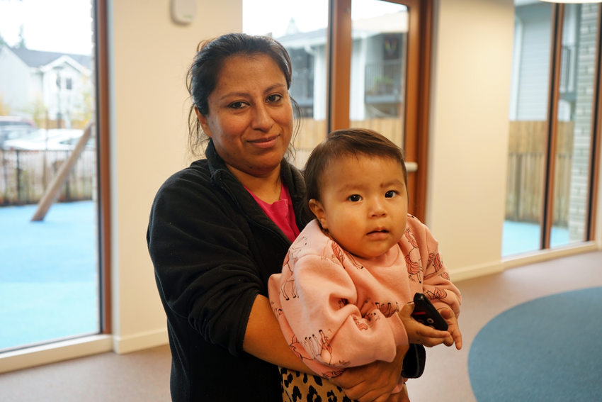 Woman holding a baby. 