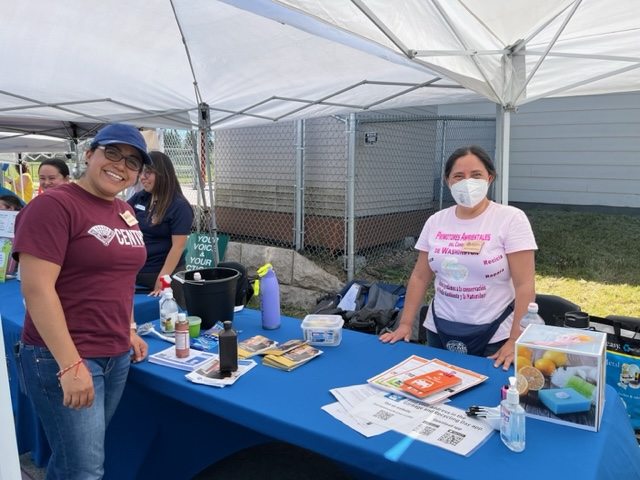 Members of the Promotores Ambientales engaged community members at the PlanetCon sustainability fair.