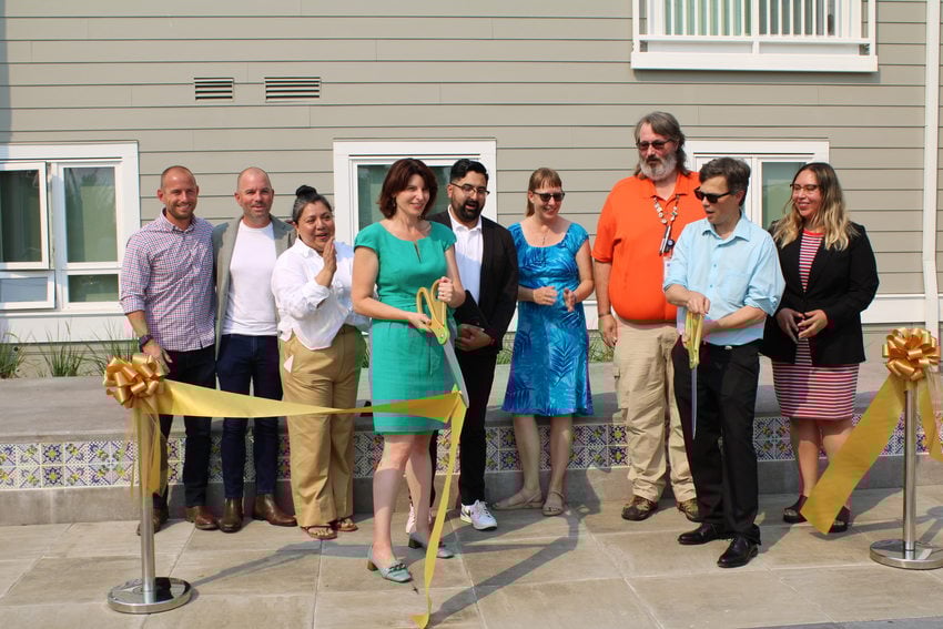 Project partners commemorate the grand opening of Plaza Los Amigos with a ribbon cutting.