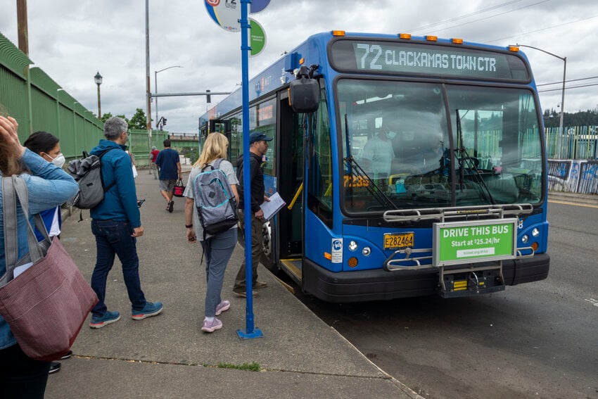 Several people line up to board the Line 72 Bus