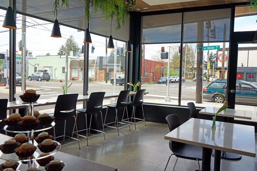 Cafe with wrap-around windows and window counter seating.
