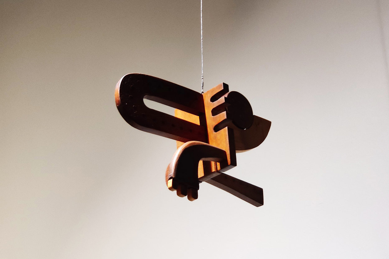 An image of an hanging wood sculpture for the GLEAN 10 year retrospective show.