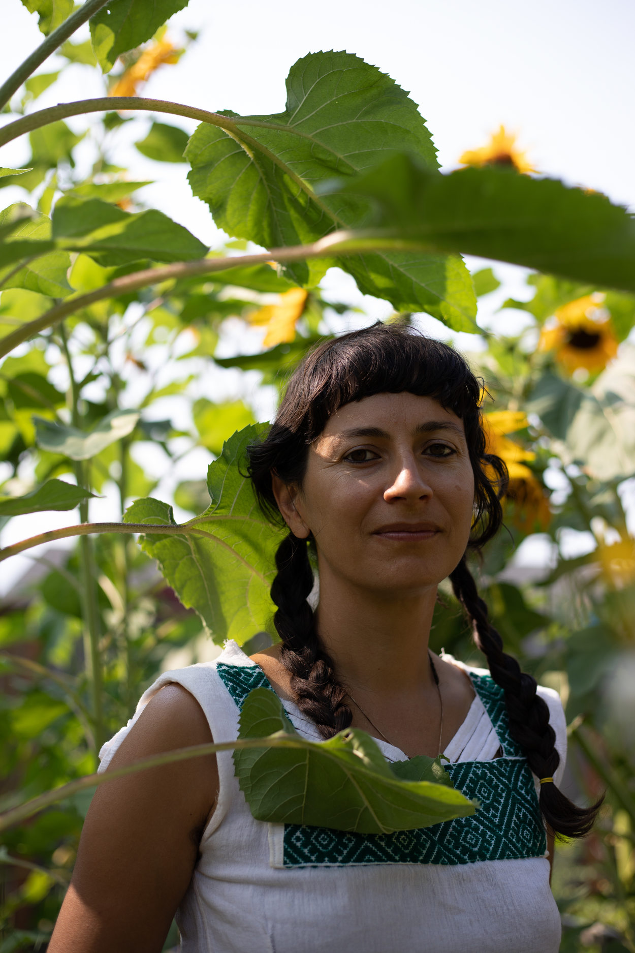 Atabey Medicine founder Lara Pacheco standing amongst sunflowers
