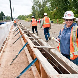 photo of a woman working on light rail construction