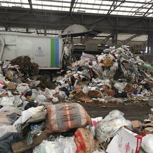 garbage truck emptying its load at Metro's Central transfer station