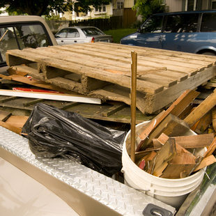 wood waste loaded into the bed of a pickup