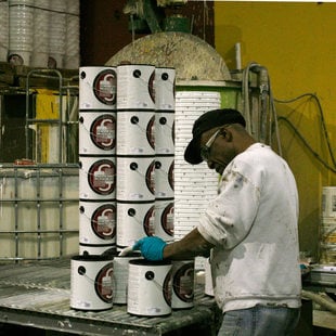 Paint cans are filled with recycled paint at MetroPaint's Swan Island facility on Oct. 30, 2015.
