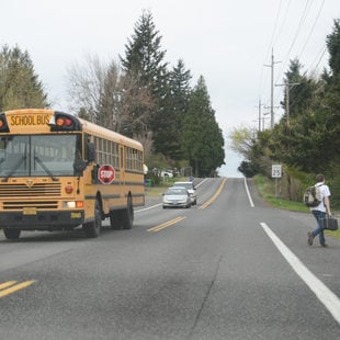 Student getting off school bus in Gresham