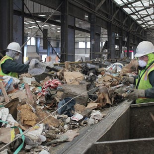 Recology workers sort through dry waste, pulling all recyclables from the waste stream. All dry waste at the facility goes through this process. 