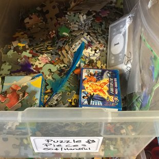 puzzle pieces and used board games to be recycled