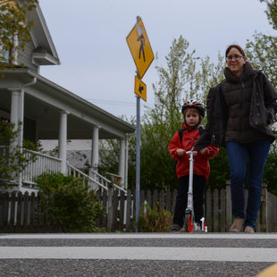 A mother and son cross a crosswalk in Southeast Portland