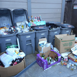 grey recycling bins overflowing with materials to be recycled