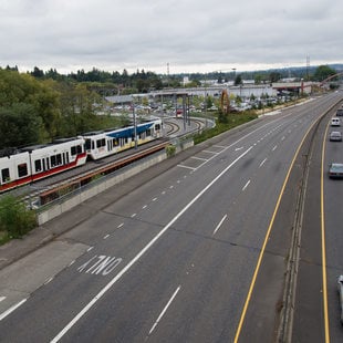 Image of MAX train alongside freeway