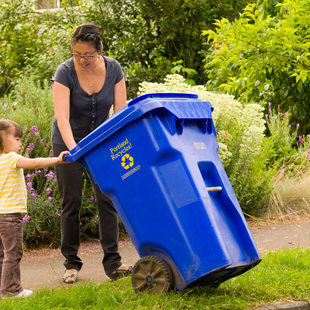 Image of mom and child with recycling bin