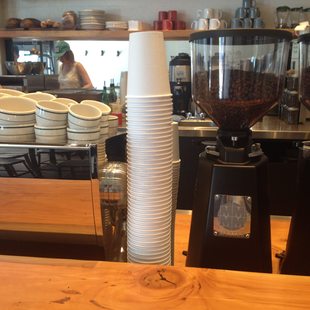 Stack of paper coffee cups at a cafe