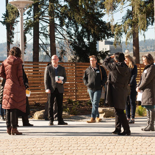 People speaking at the St Francis Park apartments in Portland