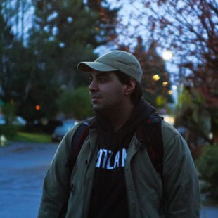 A young man looks to the side in the morning light