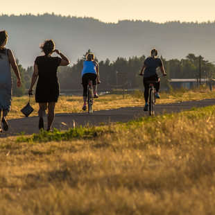 People walking and biking on a trail