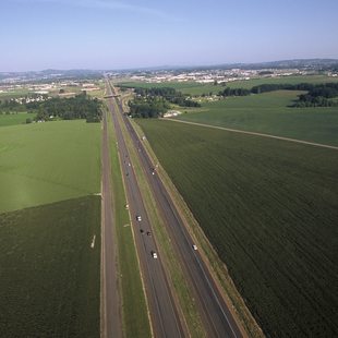 Photo of a highway with farm fields on either side