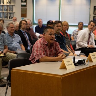 A man gives testimony about the Southwest Corridor plan at a meeting in Tigard