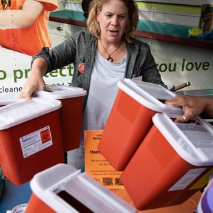 metro employees hand out free sharps containers