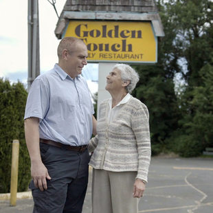 a portrait of a son and mother standing on property they own along Barbur Boulevard in Southwest Portland