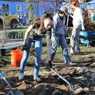 photo of children planting trees at M&M Marketplace