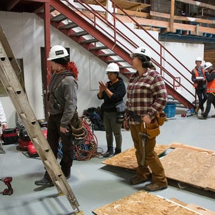 a group of women in construction gear, working as part of their pre-apprenticeship training program