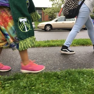 Middle school students walk along a completed sidewalk