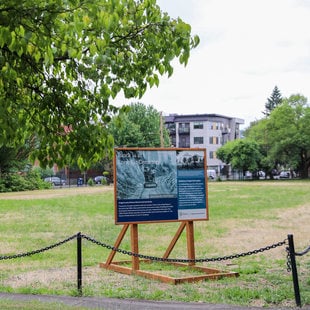 A sign on Block 14 lot at Lone Fir Cemetery, under trees