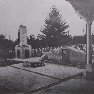 old monochrome photo of Chinese cemetery with a roast pig presented at an altar as an offering and a funerary burner to the side of the altar