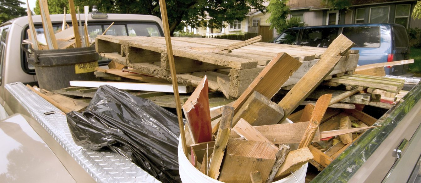 Treated wood in the back of a pickup truck.